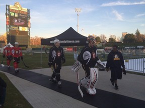 Joni Ortio leads the Stockton Heat out for practice at Raley Field in Sacramento, Calif, on Thursday, Dec. 17, 2015.