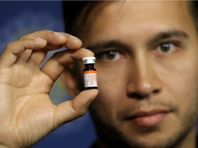 Dr. Nicholas Etches, the medical officer of health for the Calgary area, holds naloxone, a medication that reverses the effects of overdoses on opioids, including fentanyl. Etches was at a news conference in Calgary on Aug. 13, 2015.