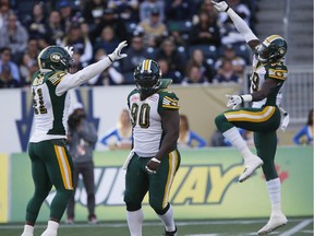 Edmonton Eskimos' Odell Willis (41) and Willie Jefferson (99) celebrate Almondo Sewell's (90) sack on Winnipeg Blue Bombers quarterback Matt Nichols (15) during the first half of CFL action in Winnipeg on Oct. 3, 2015. Sewell says he is very happy to have re-signed with the Eskimos for another two years.