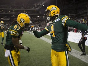 Edmonton Eskimos' Adarius Bowman (4) celebrates his touchdown with teammate Derel Walker (87) against the Ottawa Redblacks in the 103rd Grey Cup on Nov. 29, 2015, in Winnipeg. Both players were named to theCFL all-star team.