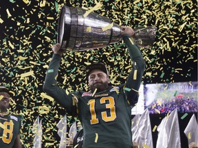 Eskimos quarterback Mike Reilly holds the Grey Cup after Edmonton defeated  the Ottawa Redblacks at the 103rd Grey Cup on Nov. 29, 2015 in Winnipeg.