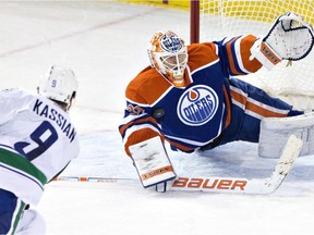 Zack Kassian of the Vancouver Canucks is stopped by Edmonton Oilers goalie Ben Scrivens during an NHL game at Rexall Place on Nov. 19, 2014.