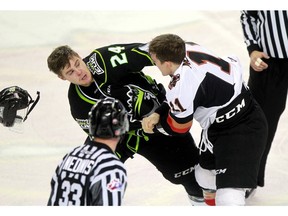 Edmonton Oil Kings' Aaron Irving, 24, and Calgary Hitmen player Beck Malenstyn mix it up as the Calgary Hitmen played host to the Edmonton Oil Kings on Saturday, Jan. 16, 2016 at the Scotiabank Saddledome.