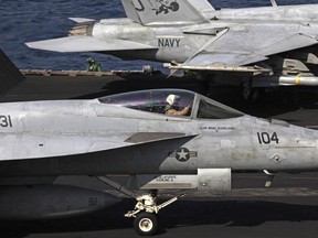 U.S. F/A-18 fighter jets prepare to take off for Iraq from the flight deck of the U.S. Navy aircraft carrier USS George H.W. Bush in the Persian Gulf, Monday, Aug. 11, 2014. U.S. military officials said American fighter aircraft struck and destroyed several vehicles Sunday that were part of an Islamic State group convoy moving to attack Kurdish forces defending the northeastern Iraqi city of Irbil. (AP Photo/Hasan Jamali)