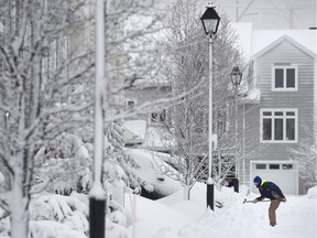 A man clears snow during a snow storm in Halifax on Jan. 13, 2016. A winter storm warning remains in effect for much of the Maritimes bringing a predicted 15 to 25 centimetres of snow.