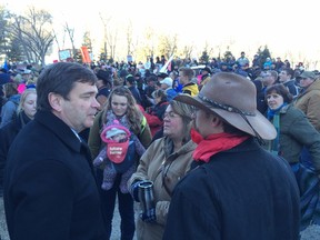 Alberta Agriculture Minister Oneil Carlier (left) talks with farmers during a protest rally against Bill 6 Nov 30, 2015.