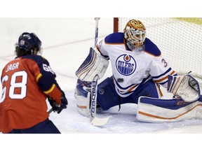 A shot by Florida Panthers left wing Jussi Jokinen, not shown, deflects off Edmonton Oilers goalie Cam Talbot (33) during the second period of an NHL hockey game, Monday, Jan. 18, 2016, in Sunrise, Fla. The Oilers won 4-2.