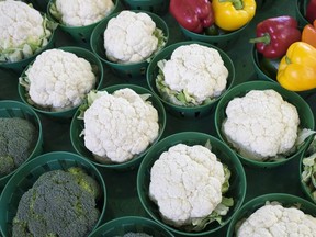 Cauliflowers, surrounded by broccoli and peppers, are seen at the Jean Talon Market, Monday, January 11, 2016 in Montreal. The soaring price of cauliflower is forcing restaurants offering signature dishes featuring the trendy vegetable to rethink menus and raise prices.