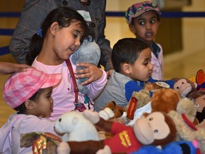 Refugee children got to choose stuffed animals during a celebration at City Hall to welcome their families  to Edmonton Jan. 8.