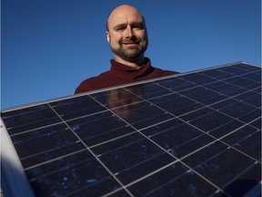 Curtis Buxton, a project manager at Skyfire Energy Inc., who was forced to look for new employment after being downsized out of the oil and gas industry, poses with solar panels, in Calgary on Jan. 25, 2016.