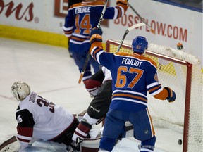 Benoit Pouliot of the Edmonton Oilers celebrates a goal scored by Jordan Eberle on Arizona Coyotes goaltender Louis Domingue during an NHL game on Jan. 2, 2016, at Rexall Place.