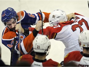 Florida Panthers' Nick Bjugstad (right) and Edmonton Oilers' Eric Gryba fight during a game at Rexall Place on Jan. 10, 2016.
