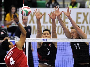 Canada's Dallas Soonias, centre, and Dan Jansen Vandoorn, right, defend against Mexico's Gonzalo Ruiz de La Cruz during men's Continental Olympic Qualification volleyball action at Saville Centre in Edmonton Jan. 8, 2016.