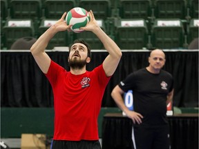 Nicholas Hoag sets a ball while his father and coach, Glenn Hoag, watches during a Canadian men's volleyball team training session at the Saville Community Sports Centre on Jan. 7, 2016.