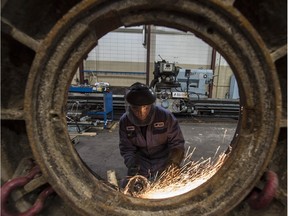 Work is done on a rock crusher at Universe Machine, an Edmonton manufacturing company that marked its 50th anniversary in 2015.