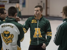 Karsten Sturmay and his Saville Centre teammates get pointers from their coach on Dec. 31, 2015, prior to successfully defending the Alberta junior men's curling championship that Karsten won last year.