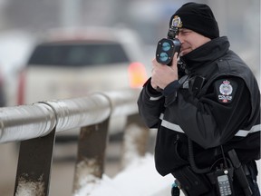A EPS traffic officer aims laser radar at traffic on the James MacDonald Bridge in 2013.  The province is looking for new efficiencies in the traffic court system.