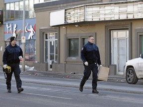 Police investigate the scene of a shooting on 111 Avenue near 93 Street in downtown Edmonton early Friday, Jan. 1, 2016.