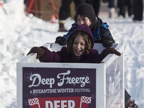 Nine-year-old Zander Ross pushes his sister Luana, 10, during the Deep Freezer races at the Deep Freeze Festival, one of nine local festivals that are part of the Alberta Avenue revitalization effort.