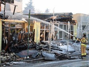 Firefighters put out hotspots on Jan. 13, 2015, during the fire that destroyed the historic Roxy Theatre at 124th Street and 107th Avenue in Edmonton.