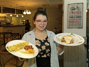 Cafe Bicyclette employee Emilie Duschesne with a spinach and feta cheese omelette (left/$10) and the Croque Madame (right/ham, smoked Gouda cheese, egg, bechtel sauce, brioche bun, $10.50).