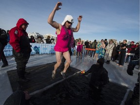 Kirk Herrick takes the plunge in a bright pink bathing suit during the annual Polar Plunge in Lake Summerside in Edmonton on Sunday, Jan. 17, 2016. The bone-chilling event was a fundraiser for Special Olympics Alberta.