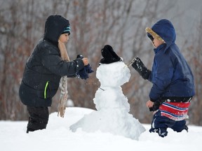 Children have fun making snowmen in Hawrelak Park, an activity some daycares are referring to as risky play.