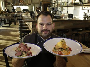 Workshop Eatery restaurant chef/owner Paul Shufelt with the Duck Duck Couscous ($32) and Alberta Pickerel ($28)