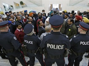 Angry Edmonton taxi drivers try to force their way into Edmonton City Council Chambers where city council was having a meeting on the Uber taxi dispute on January 26, 2016.