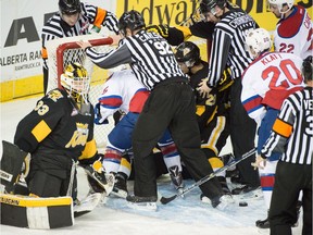 The referees try to keep control during a scrum in the Brandon Wheat Kings' goal crease during a Western Hockey League game with the Edmonton Oil Kings at Rexall Place on Jan. 1, 2016.