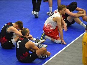 Team Canada players show their disappointment after missing a chance to qualify for the Summer Olympics when they lost in three straight sets to Cuba in the final match of the NORCECA Continental Olympic qualification men's volleyball tournament at the Saville Community Sports Centre on Sunday, Jan. 10, 2016.