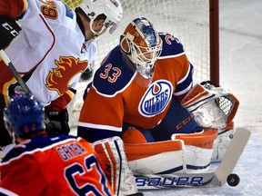 Edmonton Oilers goalie Cam Talbot makes the save as Calgary Flames' Micheal Ferland is on the doorstep at Rexall Place in Edmonton, Jan. 16, 2016.
