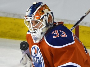 Edmonton Oilers goalie Cam Talbot makes a save in overtime against the Calgary Flames during an NHL game at Rexall Place on  Jan. 16, 2016.