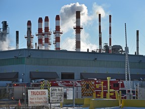 Fire trucks outside at a fire that broke out inside the Owens Corning plant on Hayter Road in Edmonton, Jan. 4, 2016.