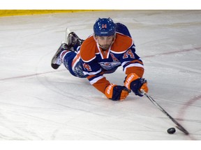 Edmonton forward Jordan Eberle dives for the puck as the Carolina Hurricanes play the Oilers at Rexall Place, Jan. 4, 2016.