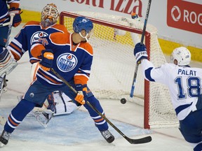 The Lightning's winning goal goes in off Darnell Nurse (25) as the Edmonton Oilers lose 3-2 to the Tampa Bay Lightning in Edmonton, Jan. 8, 2016.