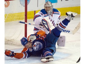 EDMONTON, ALTA: ¬†NOVEMBER 18, 2015 -- defenceman Oscar Klefbom (77) goes into goaltender Henrik Lundqvist (30) after getting tripped as the Edmonton Oilers play the new York Rangers at Rexall place  in Edmonton , Dec. 9, 2015.