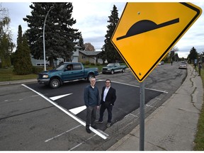 Coun. Michael Oshry, chair of council's transportation committee, and Darrell Mullen, transportation services supervisor, standing on a speed bump along 94B Avenue in Ottewell installed last September.