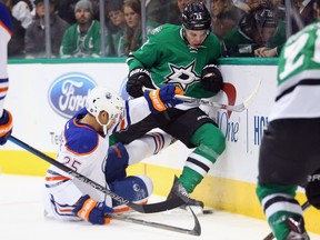 Mattias Janmark (13) of the Dallas Stars skates the puck against Darnell Nurse of the Edmonton Oilers during NHL action at American Airlines Center on January 21, 2016 in Dallas.