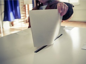 Person casting ballot.