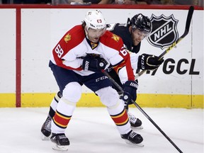 Florida Panthers' Jaromir Jagr (68) controls the puck in front of Pittsburgh Penguins' Bryan Rust (17) during the first period of an NHL hockey game in Pittsburgh Oct. 20, 2015.