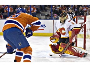 Calgary Flames goalie Jonas Hiller makes the save on Edmonton Oilers' Nail Yakupov  during first-period NHL action in Edmonton on Saturday Jan. 16, 2016.