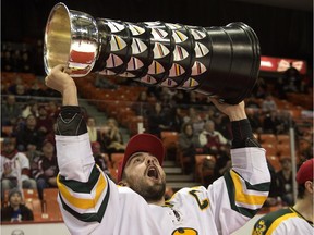 Alberta Golden Bears captain Kruise Reddick lifts the University Cup after defeating the UNB Varsity Reds to win the CIS hockey championship in Halifax on Sunday, March 15, 2015. The Bears are currently in the unfamiliar position of second place in the Canada West conference.