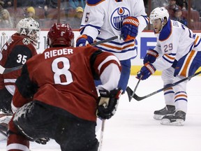 Edmonton Oilers' Leon Draisaitl sends the puck past Arizona Coyotes' Louis Domingue for a goal as Coyotes' Tobias Rieder watches on Tuesday, Jan. 12, 2016, in Glendale, Ariz.