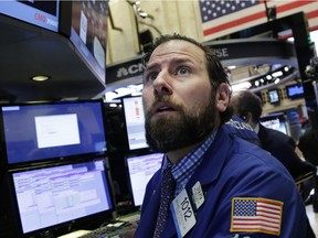 Michael Pistillo Jr. follows stock prices at the New York Stock Exchange, Friday, Jan. 15, 2016.