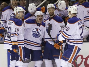 Edmonton Oilers right-winger Nail Yakupov, second from left, celebrates his second-period goal against the San Jose Sharks with teammates during NHL action in San Jose, Calif., Thursday, Jan. 14, 2016. The Sharks won a 2-1 shootout decision.