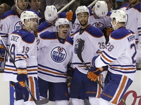 Edmonton Oilers right wing Nail Yakupov, second from left, celebrates after scoring against the San Jose Sharks, with defenseman Justin Schultz (19), defenseman Darnell Nurse (25) and left wing Lauri Korpikoski (28), from Finland, during the second period of an NHL hockey game in San Jose, Calif., Thursday, Jan. 14, 2016.