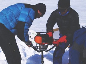 University of Alberta scientist Alexander Wolfe drills through lake ice to sample underlying sediments on Spitsbergen Island in this undated photo. Pollution found in the samples are evidence to make the case for a new geological era called the Anthropocene era, or the Age of Humanity.
