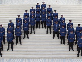 Members of Edmonton Police Service recruit training class No. 133 stand at attention during their graduation ceremony, at City Hall in Edmonton Alta. on Friday Jan. 29, 2016. Photo by David Bloom