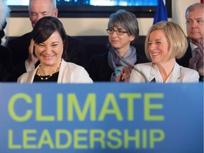 Premier Rachel Notley, right, and Environment and Parks Minister Shannon Phillips look on after unveiling Alberta's climate strategy in Edmonton on Sunday, Nov. 22, 2015.